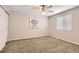 Cozy bedroom featuring neutral paint, carpet, a window, and closet at 8432 S Upham Way, Littleton, CO 80128