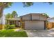 Charming single-story home with a well-manicured lawn and attached two-car garage at 8432 S Upham Way, Littleton, CO 80128
