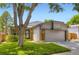 Charming one-story home with lush lawn, mature tree, and two car garage at 8432 S Upham Way, Littleton, CO 80128