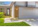 Close up of front exterior of home with brick accents and two car garage at 8432 S Upham Way, Littleton, CO 80128