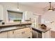 Modern kitchen with stainless steel appliances, window, and gray countertops at 8432 S Upham Way, Littleton, CO 80128