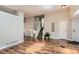 Spacious living room with wood floors, staircase, and neutral paint at 8432 S Upham Way, Littleton, CO 80128