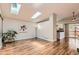 Open-concept living room with wood floors, skylights, and open floor plan at 8432 S Upham Way, Littleton, CO 80128