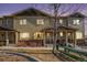Charming two-story townhome boasting a stone foundation, lush landscaping, and a cozy front porch at 1631 Aspen Meadows Cir, Denver, CO 80260