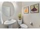 Charming powder room with pedestal sink, decorative mirror, and elegant wall art at 1631 Aspen Meadows Cir, Denver, CO 80260
