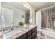 Bathroom featuring double sinks with granite countertop and a shower-tub combo at 1631 Aspen Meadows Cir, Denver, CO 80260