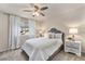 Bright bedroom featuring a comfortable bed, stylish furnishings, and a ceiling fan at 1631 Aspen Meadows Cir, Denver, CO 80260