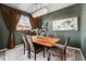 Elegant dining room boasting modern lighting, a rustic wood table, and stylish decor at 1631 Aspen Meadows Cir, Denver, CO 80260