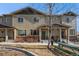 Inviting townhome featuring a covered entrance, meticulous landscaping, and a charming outdoor picnic area at 1631 Aspen Meadows Cir, Denver, CO 80260