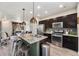 Spacious kitchen with stainless steel appliances, a center island, and open layout to the living area at 1631 Aspen Meadows Cir, Denver, CO 80260