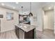 Modern kitchen island with granite countertops, stainless steel appliances, and pendant lighting at 1631 Aspen Meadows Cir, Denver, CO 80260