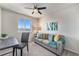 Cozy living room featuring a comfortable sofa, a desk and bright natural light at 1631 Aspen Meadows Cir, Denver, CO 80260