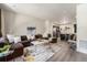 Spacious open-concept layout with a large sectional sofa and seamless flow to the kitchen at 1631 Aspen Meadows Cir, Denver, CO 80260