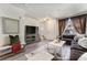 Comfortable living room showcasing a large TV, decorative mirror, and cozy seating area at 1631 Aspen Meadows Cir, Denver, CO 80260