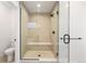 Clean bathroom showcasing a glass-enclosed shower with built-in bench and modern fixtures at 2625 W 23Rd Ave, Denver, CO 80211