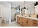 Bright bathroom featuring a double sink vanity with modern light fixtures and glass-enclosed shower at 2625 W 23Rd Ave, Denver, CO 80211