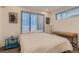 Bright bedroom with a window, side table, and a decorative picture at 2625 W 23Rd Ave, Denver, CO 80211