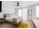 Well-lit bedroom with a ceiling fan, plush bed, and neutral decor creating a serene atmosphere at 2625 W 23Rd Ave, Denver, CO 80211