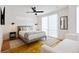Bright bedroom with minimalist decor, featuring a plush bed, modern lighting, and cozy seating at 2625 W 23Rd Ave, Denver, CO 80211