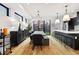Open concept dining area featuring a rustic table, modern chandelier, and access to the backyard at 2625 W 23Rd Ave, Denver, CO 80211