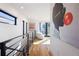 Bright hallway featuring hardwood floors, modern art, and access to a balcony with city views at 2625 W 23Rd Ave, Denver, CO 80211