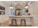 Bright kitchen with modern stainless steel appliances, island with seating, and sleek pendant lighting at 2625 W 23Rd Ave, Denver, CO 80211