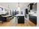 Modern kitchen features dark cabinetry, a large island with seating, and stainless steel appliances at 2625 W 23Rd Ave, Denver, CO 80211