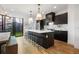 Contemporary kitchen boasts a large island with seating, and view to outdoor dining at 2625 W 23Rd Ave, Denver, CO 80211