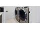 Convenient laundry room showcasing a modern washer and dryer set with stainless steel finish at 2625 W 23Rd Ave, Denver, CO 80211