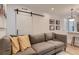 Comfortable living room featuring a gray sofa, barn doors and modern decor at 2625 W 23Rd Ave, Denver, CO 80211