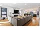 Spacious living area with hardwood floors, a large gray sectional sofa, and a contemporary fireplace at 2625 W 23Rd Ave, Denver, CO 80211