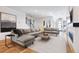 Spacious living room with gray sectional sofa, modern art, and staircase at 2625 W 23Rd Ave, Denver, CO 80211