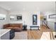 Open-concept living room featuring modern decor, hardwood floors, a leather couch, and fitness area at 2625 W 23Rd Ave, Denver, CO 80211