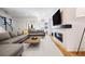 Bright living room features a gray sectional sofa and modern fireplace, creating a cozy atmosphere at 2625 W 23Rd Ave, Denver, CO 80211