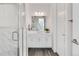 Stylish bathroom featuring a glass enclosed shower and modern vanity with sleek fixtures and clean lines at 11487 W Grand Way, Littleton, CO 80127
