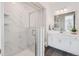 Modern bathroom featuring glass enclosed shower and modern vanity with sleek fixtures and clean lines at 11487 W Grand Way, Littleton, CO 80127