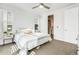 Bright bedroom with sunlit windows, neutral carpet, and a striped bedspread that offers a modern and relaxing space at 11487 W Grand Way, Littleton, CO 80127