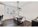 Elegant dining area with a modern light fixture and views of the backyard at 11487 W Grand Way, Littleton, CO 80127