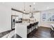 Modern kitchen features stainless steel appliances and an island with seating at 11487 W Grand Way, Littleton, CO 80127