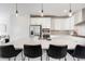 Modern kitchen boasts a large island with seating and stainless steel appliances at 11487 W Grand Way, Littleton, CO 80127