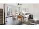 Inviting living area features sleek wood floors and a contemporary ceiling fan at 11487 W Grand Way, Littleton, CO 80127