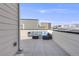 A rooftop deck provides stylish outdoor seating with panoramic views of the city skyline and surrounding neighborhood at 11487 W Grand Way, Littleton, CO 80127
