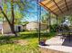 Spacious backyard with a covered patio, green lawn, and storage sheds at 2695 S Logan St, Denver, CO 80210