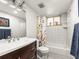 Clean bathroom with a shower-tub combo, colorful curtain, and a wooden vanity at 2695 S Logan St, Denver, CO 80210