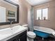 Classic bathroom featuring stylish blue clawfoot tub, black tile flooring and neutral walls at 2695 S Logan St, Denver, CO 80210