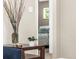 View into a bedroom with neutral walls and trim, as well as natural light from a window at 2695 S Logan St, Denver, CO 80210