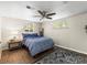 Cozy bedroom featuring a ceiling fan, wood floors, and natural light from windows at 2695 S Logan St, Denver, CO 80210