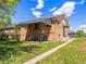 Brick home with a covered patio and well-maintained lawn at 2695 S Logan St, Denver, CO 80210