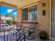Relaxing front porch with seating area, brick facade, and classic outdoor light fixture at 2695 S Logan St, Denver, CO 80210