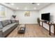 Cozy finished basement living room with plush seating, ample lighting, and contemporary design at 2695 S Logan St, Denver, CO 80210
